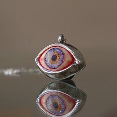 Blue Eye Pendant, Evil Eye Talisman Pendant, Glass Blue Eye Necklace, Evil Eye Necklace, Eye Jewelry, Gift Idea, Handmade Eye Jewelry My eye designs can be made specifically for your eyes, you need to take a beautiful iris photo for us. Then we can customize it for you. You can also add or remove blood details to our eye designs. You can write this in the order notes. Please send me a message after ordering. I can do as you wish. A quasi-universal symbol of protection, the evil eye is referred t Eye-catching Handmade Jewelry For Gifts, Eye-shaped Amulet Necklace As Gift, Eye-catching Evil Eye Jewelry For Gift, Amulet Eye Necklace Gift, Symbolic Eye-shaped Jewelry Gift, Blue Symbolic Collectible Jewelry, Handmade Symbolic Blue Necklaces, Unique Evil Eye Jewelry Gift, Unique Evil Eye Jewelry As A Gift