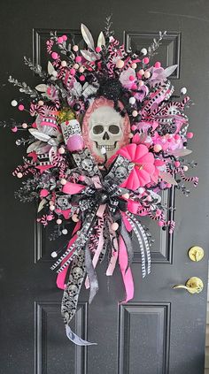 a door decorated with pink and black flowers, skulls and ribbons on it's side