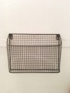 a metal basket hanging on the wall