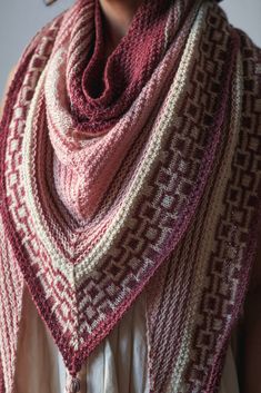 a woman wearing a red and white knitted shawl