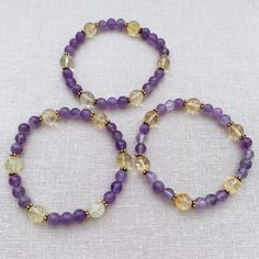 This is such a beautiful stretch braclet combination of lemon Citrine and Amethyst. Handmade bracelet is crafted with round polished 8mm beads. Each quartz is attached on a strong elastic string. Comfort fits anyone who has 6.5 to 7 inches (17cm) wide wrist. The genuine purple and yellow gemstone bracelet is a beautiful gift idea for anyone who loves handmade chakra energy healing jewelry. They come in a small cardboard box for jewelry. MATERIAL: Citrine, Amethyst, Gold Plated Brass, Pink Elasti Yellow Spiritual Crystal Bracelet, Spiritual Faceted Round Beads Stretch Bracelet, Spiritual Stretch Bracelet With Faceted Round Beads, Yellow Spiritual Crystal Bracelet With 8mm Beads, Yellow Crystal Bracelet With Round Beads For Healing, Yellow Crystal Healing Bracelet With Round Beads, Spiritual Citrine Beaded Bracelets, Yellow Round Bead Bracelets For Meditation, Yellow Spiritual Stretch Bracelet