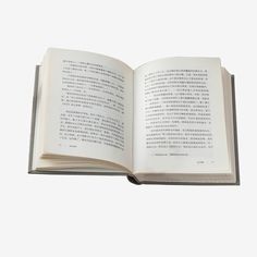 an open book with chinese writing on the pages and in english, it is white