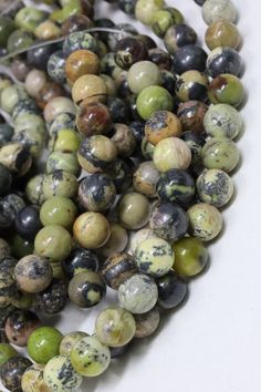 the beads are multicolored and have black, green, yellow and white speckles