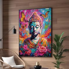 a buddha painting hanging on the wall above a table with a chair and potted plant