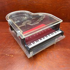 a heart shaped piano sitting on top of a wooden table