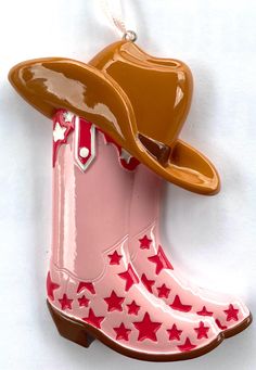 Bring a touch of country flair to your holiday décor with this adorable cowgirl boot ornament! Featuring a light pink boot adorned with bold red stars and topped with a classic brown cowboy hat, this ornament perfectly captures the spirit of the Wild West. Whether you're a rodeo lover, country music fan, or simply enjoy a western theme, this ornament will make a playful and unique addition to your Christmas tree. Perfect for cowgirls at heart or as a gift for someone who loves all things western, this durable and lightweight ornament adds a festive, rustic touch to your holiday celebrations. Personalize it with a name or message to make it extra special! Check out the last photo to choose which font you want for personalization! Pink Western Boots For Ranch, Pink Western Boots For Rodeo, Light Pink Boots, Boot Ornament, Brown Cowboy Hat, Pink Cowboy Boots, Red Stars, Chapeau Cowboy, Far West