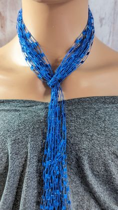 *A beautiful holiday gift* This simple yet stunning blue silver sassy necklace scarf is 48 inches long handmade using 9 strands of blue silver laddere yarn.Add a pop of color to your everyday wardrobe,. this beautiful blue silvery color goes with just about everything.can easilly go from work to play with this eye catcher. This simple design makes it easy to dress up or down for any occasion, work or a night out. This elegant and charming scarf necklace is lightweight and looks great with any outfit a versatile look to enhance your style buy it for yourself a loved one or a friend this piece is a great holiday gift. *My goal is to make sure you receive exactly what you're looking for and for your experience to be a special and memorable one. I am ready to help you with your jewelry purchas Blue Lariat Necklace For Party, Blue Lariat Jewelry For Party, Ladder Yarn Necklace, Ladder Yarn, Necklace Scarf, Yarn Necklace, Scarf Necklace, I Am Ready, Blue Necklace