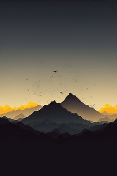 birds flying over the mountains at sunset