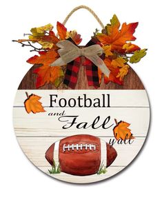 a wooden sign with a football and fall leaves on it