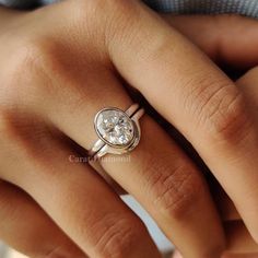 a woman's hand with a diamond ring on it