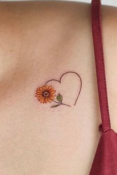 a sunflower tattoo on the back of a woman's left shoulder and chest