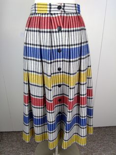 Such a Fun Skirt to wear! Black Red White Yellow Blue Stripes with 7 Black Buttons down front. Wonderful Italian Fabric! 50%Viscose/45%Poly/5% Other Fibers - Dry Clean No Stretch VGVC with no flaws noted Size 10 - Refer to Measurements: Waist/28" Hip/34" Length/30" Smoke & Pet Free Studio Retro Multicolor Pleated Skirt, Retro Multicolor Midi Skirt, Retro Multicolor Pleated Skirt Bottoms, Striped Midi Skirt, 80s Vintage, Box Pleats, Italian Fabric, Black Button, Yellow Blue