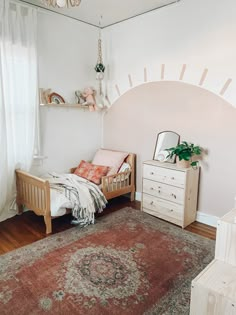 a bedroom with a bed, dresser and rug