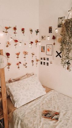 a bed room with a neatly made bed and lots of flowers on the wall above it