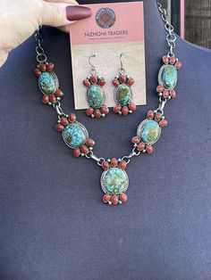 New without tags BRAND : Sterling JEWELRY TYPE : Necklaces MAIN STONE : Multi-Stone METAL : Sterling Silver ARTISAN : Kathleen Chavez I can’t believe this piece from our Taos Collection. Incredible Hand Crafted Navajo Sterling Silver with Natural Coral and Kingman Turquoise Necklace . Measuring 20 inches long. Beautiful Kingman Turquoise and Natural Red Coral Stones on 5 Pendant Pieces. Matching Dangle Earrings are 2 inches long and 3/4 of an inch wide. Signed by Artist Kathleen Chavez. Stamped Turquoise Multi-stone Round Jewelry, Red Multi-stone Jewelry, Southwestern Multi-stone Turquoise Jewelry, Southwestern Multi-stone Pendant Jewelry, Southwestern Red Jewelry With Natural Stones, Southwestern Style Collectible Jewelry With Large Stone, Artisan Red Gemstone Jewelry, Oval Turquoise Multi-stone Jewelry, Southwestern Style Large Stone Collectible Jewelry