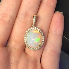 This gorgeous opal pendant can be worn with a simple chain or attached to a string of pearls to make an elegant necklace! Oval Ethiopian Opal Necklace For Formal Occasions, Elegant Opal Necklace With Large Pendant, Elegant Ethiopian Opal Cabochon Necklaces, Elegant Ethiopian Opal Jewelry With Cabochon, Elegant Ethiopian Opal Necklace In Yellow Gold, Elegant Ethiopian Opal Cabochon Jewelry, Formal Ethiopian Opal Cabochon Necklaces, Formal Opal Pendant Jewelry, Formal Oval Ethiopian Opal Necklace