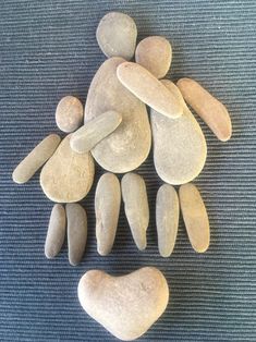 some rocks are arranged in the shape of a person's head on a blue surface