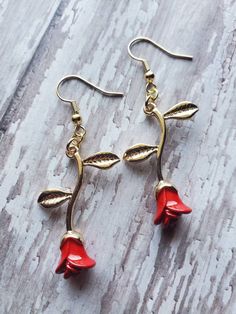 Everlasting roses! Beautiful roses symbolizing love like no other. These gorgeous dainty roses are created of gold plated precious metals with vivid enamel red roses. The earrings dangle at 2.25 inches (half of an inch in width) and are extremely light weight. The earrings have super intricate detailing for a once of a kind realistic look. The earrings are great for any occasion, and if the love for roses are endless then these are the perfect statement!  Purchases will be shipped within 3-5 bus Flower Shaped Rose Design Jewelry For Valentine's Day, Valentine's Day Rose Design Flower Jewelry, Valentine's Day Flower Rose Design Jewelry, Rose Flower Earrings As Gift, Rose Flower Earrings For Gift, Rose Red Flower Earrings With Rose Design, Flower Shaped Rose Earrings For Gift, Rose Flower Earrings For Valentine's Day, Rose Red Flower-shaped Jewelry For Valentine's Day