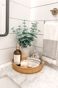 a bathroom sink with soap, lotion and other items on it