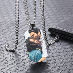 an image of a man and woman in love on a dog tag necklace with chain