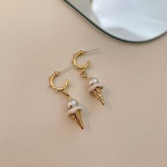 Description:Ice Cream Pearl Earrings Specifications:Size: 3.8 cm * 1.2 cmWeight: 6 g/pairMaterial: Alloy, Bronze, Artificial PearlColor: Gold/Silver Indulge your sweet side with these whimsical Ice Cream Pearl Earrings. Featuring playful ice cream cone designs with lustrous pearl accents, these earrings are the perfect addition to your fun and quirky style. Treat yourself or someone special to these delightful and unique earrings! 🍦💎 White Alloy Drop Earrings, Minimalist Alloy Drop Earrings, Alloy Drop Earrings With Ear Wire, Trendy Alloy Earrings As Gift, White Alloy Dangle Earrings, Trendy Pierced Alloy Hoop Earrings, White Alloy Pierced Earrings, White Dangle Alloy Earrings, Silver Alloy Drop Pearl Earrings