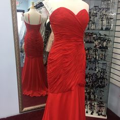 Red Dress Fit And Flair Red Evening Dress For Prom Season, Sweetheart Neckline, Elegant Red Ruched Gown, Red Sleeveless Maxi Dress With Ruched Bodice, Red Sweetheart Neckline Prom Evening Dress, Red Evening Gown With Pleated Bodice, Evening Gown With Pleated Bodice In Red, Red Gown With Pleated Bodice For Evening, Red Cocktail Gown For Prom Season, Red Sleeveless Evening Dress For Cocktail