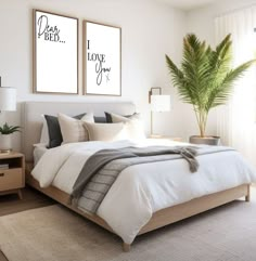 a bedroom with two posters on the wall above the bed, and a potted plant in the corner