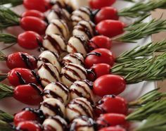 several skewered vegetables are arranged on a white plate