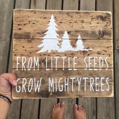 someone is holding up a sign that says, from little seeds grow mighty trees