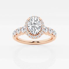 a rose gold engagement ring with diamonds on the band and an oval center stone in the middle