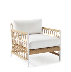 a wicker chair with white cushions on a white background