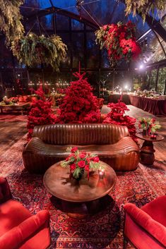 a room filled with lots of red furniture and decorations