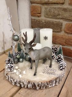 an image of a christmas cake with reindeer decorations on the top and candles in the middle