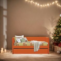 an orange daybed in front of a christmas tree