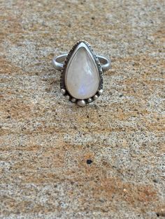 Beautiful pear shaped moonstone in a hand forged, sterling silver setting.  This hand crafted, sterling silver moonstone ring also features tiny silver balls, adding interest, texture, and a hand crafted appeal.  Simple sterling silver band allows the moonstone and setting to be the focal piece. If you love boho inspired, moonstone jewelry, this ring will be a perfect statement piece for your everyday wear. Ring size: 7 1/4 Teardrop Moonstone Gemstone Ring, Spiritual Teardrop Moonstone Ring, Handmade Moonstone Teardrop Ring, Silver Teardrop Moonstone Ring, Adjustable Teardrop Moonstone Ring In Sterling Silver, Silver Pear-shaped Moonstone Ring, Spiritual Moonstone Teardrop Ring, Sterling Silver Teardrop Moonstone Ring, Silver Teardrop Moonstone Ring In Sterling Silver