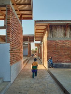 two children are walking down an alley way