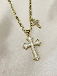 Add a touch of elegance and faith to your jewelry collection with this stunning 14k gold filled double cross necklace. The standout piece features a large cross pendant adorned with shimmering opal shell detailing, complemented by a delicate cubic zirconia cross charm. Perfect for adding a glamorous touch to any outfit, this necklace is sure to make you shine bright wherever you go. Ideal for those who want to showcase their faith with style and sophistication. 17.5 inch length with optional 2 i Double Cross Necklace, Catholic Cross Necklace, Shell Cross, Cross Pendent, Number Jewelry, Necklace Christian, Pink Cross, Catholic Jewelry, Gold Cross Necklace