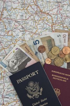 passport, money and euro coins on a map