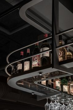 several bottles and glasses are on the shelf