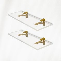 two white trays with gold handles on them