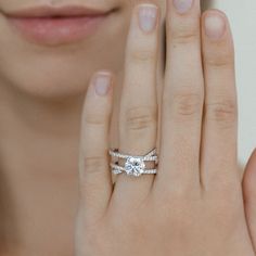 a close up of a person with two rings on their fingers and one ring in the other hand