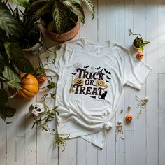 Trick or treat-themed t-shirt perfect for Halloween celebrations. Made with 100% Airlume combed and ring-spun cotton, this lightweight tee is breathable and ideal for active and leisure wear. The retail fit and crew neckline add a classic style that's perfect for casual and semi-formal settings. Suitable for both men and women. Product features - 100% Airlume combed and ring-spun cotton - Lightweight fabric (4.2 oz/yd²) - Retail fit for casual and semi-formal settings - Various fabric blends ava Themed White T-shirt For Fall, Halloween Themed Pre-shrunk T-shirt, Pre-shrunk Themed T-shirt For Halloween, Halloween Themed White T-shirt, Novelty White T-shirt For Halloween, White Halloween Themed T-shirt, Themed White T-shirt For Halloween, Themed White Halloween T-shirt, Themed Halloween T-shirt With Custom Print