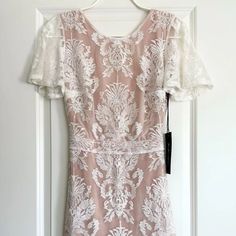 Nwt For Love & Lemons San Marcos Ivory Floral Lace Open Back Mini Dress! Description: Stunning Mini Dress!!! Perfect For A Summer Concert, Date Night Or Any Special Occasion:) Size: S Color: Ivory Fabric: Self: 40% Polyamide, 40% Cotton, 20% Polyester Lining: 87% Polyester, 13% Spandex Details: Floral Ivory Lace, Short Flutter Sleeves, Curving Hugging, Wispy Hem, Gorgeous Open Back, Hidden Side Zip, Fully Lined In Contrasting Nude. Measurements: Taken Flat Shoulders: Approx. 15" (Seam To Seam) C Wedding Maxi Dress With Lace Short Sleeves, Wedding Maxi Dress With Lace Sleeves, Elegant Cream Dress With Lace Sleeves, Elegant Cream Dresses With Lace Sleeves, Elegant Dresses With Lace Sleeves For Wedding Night, Elegant Wedding Night Dress With Lace Sleeves, Feminine Wedding Maxi Dress With Lace Sleeves, Fitted Beige Dress With Lace Sleeves, Feminine Cream Wedding Gown