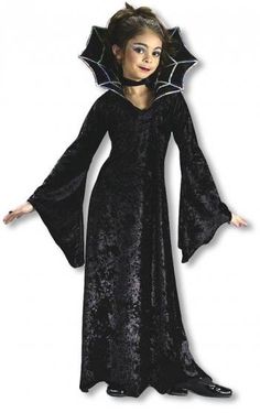 a woman wearing a black costume with a bat on it's head and long sleeves