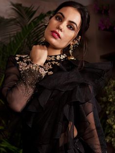 This pre-stitched ruffle saree is suited for any occasion. The saree is made of satin-silk with organza ruffles.  It is paired with a full sleeves blouse embellished with zardosi, pearls and cut-dana on the hem of the sleeves with the rose motifs on the blouse. Traditional Organza Pre-draped Saree For Party, Formal Bollywood Organza Pre-draped Saree, Semi-stitched Georgette Blouse Piece With Ruffles, Bollywood Style Ruffled Organza Pre-draped Saree, Silk Sharara For Diwali Evening, Bollywood Style Ruffled Saree For Evening, Silk Sharara For Evening And Diwali, Festive Ruffled Organza Blouse Piece, Evening Organza Saree With Ruffles