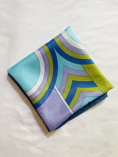 Vintage blue, purple, green geometric print square scarf, very much giving Pucci. 100% acetate. Measures: approx. 26.75" x 26" Trendy Blue Square Silk Scarf, Trendy Multicolor Square Silk Scarf, Bethany Beach, Square Scarf, Purple Green, Scarf Print, Geometric Print, Blue Purple, Scarf Wrap