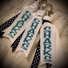 three ribbon keychains with the words happy birthday on them, and polka dots