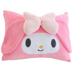 a pink pillow with a hello kitty face on it's side and a bow at the top