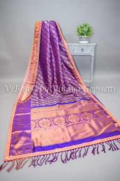 Experience the luxurious blend of purple Kanchi silk and intricate copper and silver zari work in this saree and blouse set. Handwoven and adorned with embroidered borders, it exudes an elegant and vibrant aura. Elevate your traditional wear with this stunning piece. The accompanying saree blouse is tailored with handcrafted tassels. The attention to detail further enhances it and gives the blouse a great finish. Bollywood Style Purple Raw Silk Pre-draped Saree, Purple Art Silk Pre-draped Saree With Self Design, Designer Raw Silk Purple Saree, Designer Purple Raw Silk Saree, Purple Pre-draped Saree With Zari Work In Raw Silk, Designer Purple Raw Silk Pre-draped Saree, Purple Pre-draped Saree With Zari Work, Designer Purple Tussar Silk Traditional Wear, Purple Raw Silk Pre-draped Saree With Zari Work