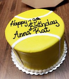 a birthday cake with a tennis ball on it